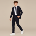 Person wearing a black suit with white shirt and white sneakers on a white background